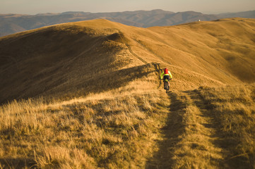 Autumn mountain scene riding with a mountain bike equipped with travel bags