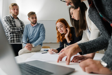 Company team analyzing data at the office desk