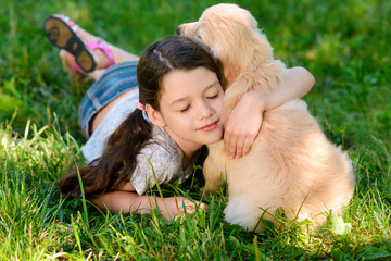 Cute girl hugging her dog