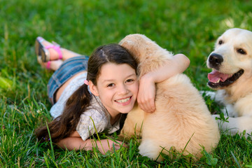 Smiling child hugging a puppy