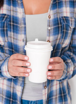 Woman holding cup of coffee. Mockup for design