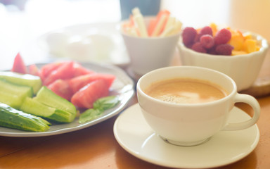 Breakfast with coffee, egg, vegetables and fruits