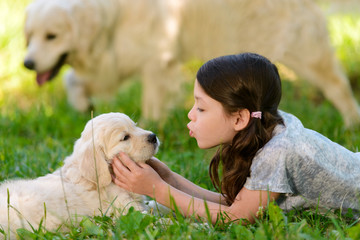 Girl playing with dog's neb