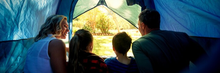 Family sitting in the tent - obrazy, fototapety, plakaty