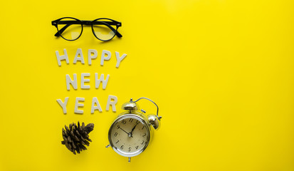 Symbol Celebration Happy new Year with black glasses and vintage o'clock on a yellow paper...