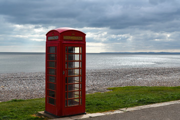 A lonely Telephone booth on the promenade of Budleigh Salterton on the  south west coast of Britain.