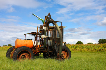 Farm Machine In Field With Light Clouds and Blue Sky