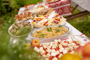 Table with traditional food from Romania and Moldova with cheese, apples and fresh tomatoes