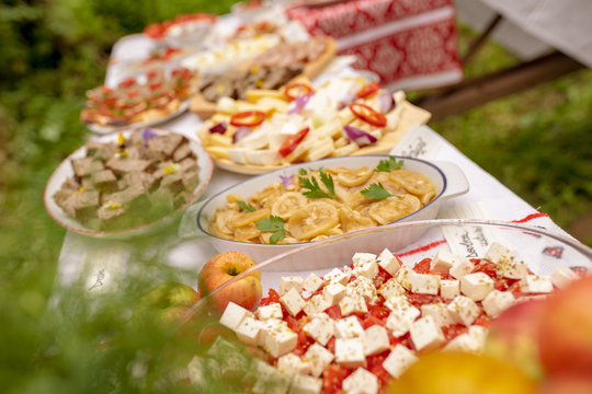 Table with traditional food from Romania and Moldova with cheese, apples and fresh tomatoes