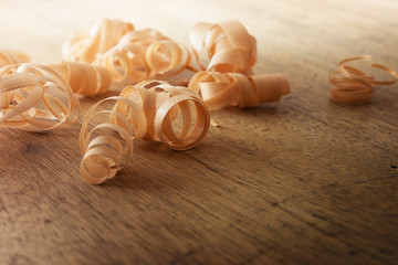 Beautiful wood shavings, on an old work desk. Shallow depth of field.