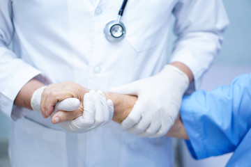 Doctor holding Touching hands Asian senior or elderly old lady woman patient with love, care, helping, encourage and empathy at nursing hospital ward : healthy strong medical concept 