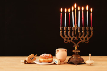 image of jewish holiday Hanukkah background with menorah (traditional candelabra) and burning...