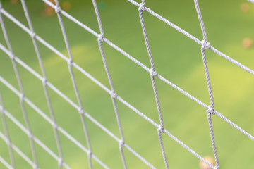 Football net close up on green grass football field background