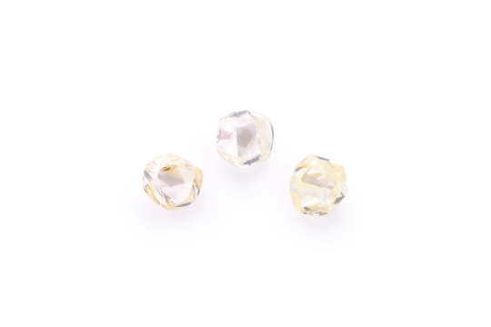 three faceted natural transparent diamonds in macro