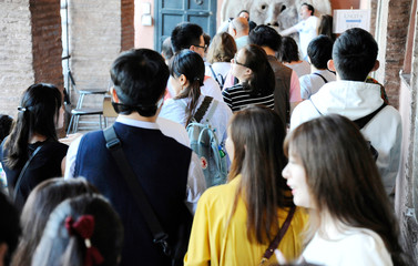 Fototapeta premium Visitors waiting to see the mouth of truth (Bocca della Verità). It attracts visitors who audaciously stick their hand in the mouth. Santa Maria in Cosmedin in Rome, Italy