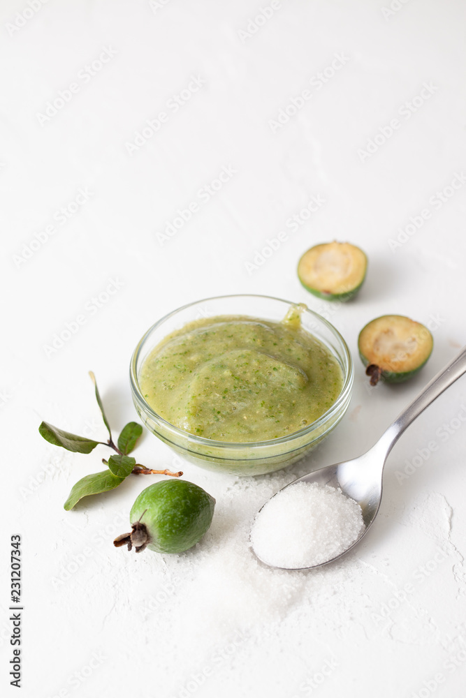 Wall mural fresh raw fruits of feijoa grated with sugar on white