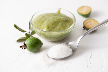 Fresh raw fruits of feijoa grated with sugar on white