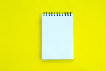 Notebook on yellow background.