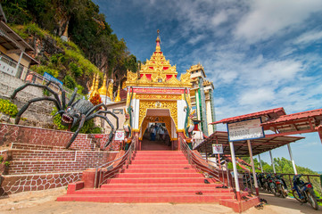 Representation of the legend at the entrance pilgrimage caves where young Prince Kummabhaya killed giant spider to save seven princesses, Myanmar.