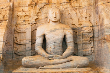 Fototapeta na wymiar Buddha statue at Gal vihara temple in Polonnaruwa, Sri Lanka. The temple has four rock relief statues of the buddha carved of a large rock.