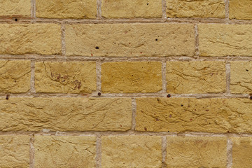Antique textured brick wall with cement masonry. Powerful strong brickwork of bright unusual color. Gorgeous grunge texture for designer background.
