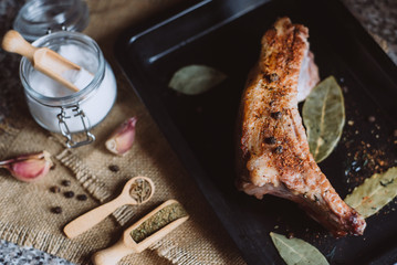 raw meat on in a metal box on dark background