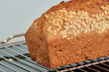 close up of a wholemeal bread on a silver oven rack, fresh baked