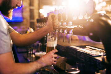 Bartender pouring beer.