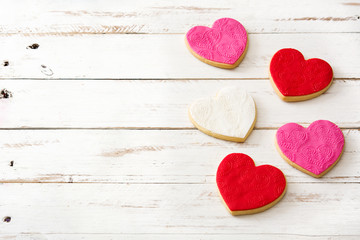 Heart-shaped cookies for Valentine's Day on white wooden table. Copyspace