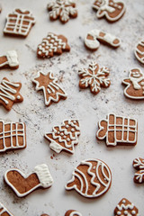 Composition of delicious gingerbread cookies shaped in various Christmas symbols. Placed on white rusty table. Top view.