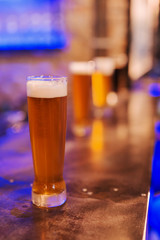 Glass of fresh beer on table.
