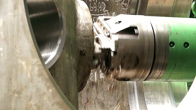 huge lathe closeup, large spindle lathe is rotating at an industrial plant. Shooting is made at a plant producing power steam turbines,Turning lathe in action,Industrial CNC drill machine