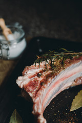  raw meat on in a metal box on dark background
