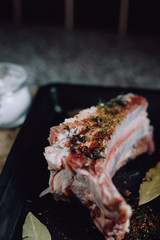  raw meat on in a metal box on dark background