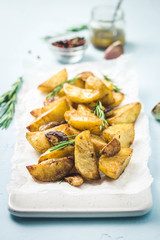 Roasted garlic herbs potato wedges. Selective focus, space for text.