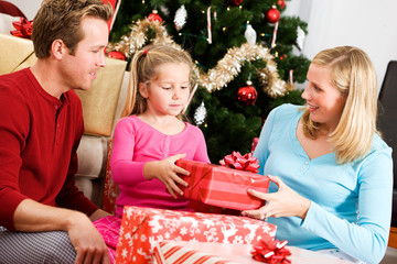 Obraz na płótnie Canvas Christmas: Family Opening Christmas Presents