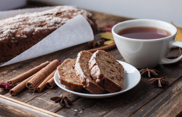 Homemade banana bread with anis star and cinnamon on a dark wooden background