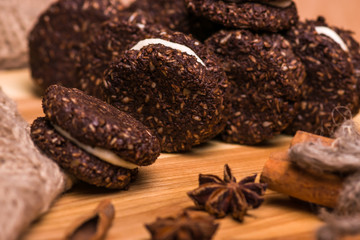 Cookies closeup. Chocolate cookies with nuts, cinnamon and cardamom on a wooden table.