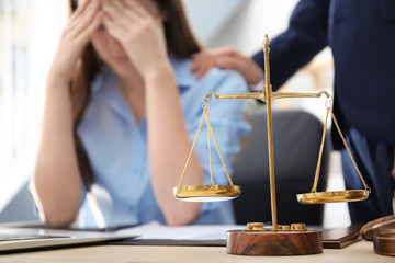 Scales of justice on table in lawyer's office