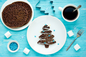 Christmas tree chocolate pancakes for kids breakfast or dessert, creative christmas new year food art © san_ta