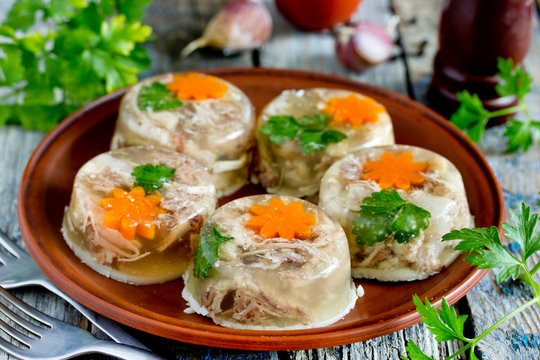 Jellied meat kholodets, meat aspic with vegetables and green parsley