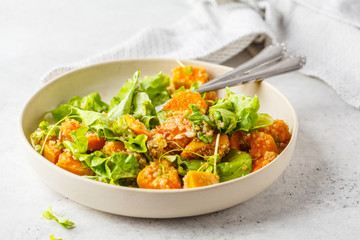 Warm quinoa and pumpkin salad in a white plate.