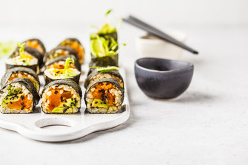 Vegan sushi rolls with pumpkin, brown rice and avocado.