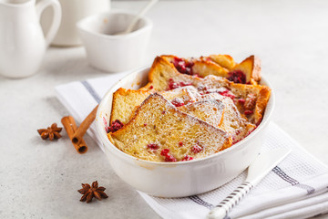 French toast casserole with raspberries, powdered sugar and cinnamon.