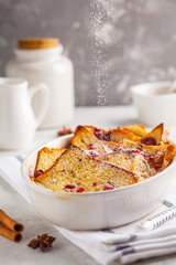 Fototapeta na wymiar French toast casserole with raspberries, powdered sugar and cinnamon.