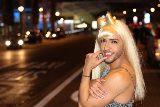 Muscular transvestite with beard and blonde wig