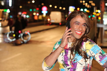 African American transgender woman calling by phone outdoors - Powered by Adobe