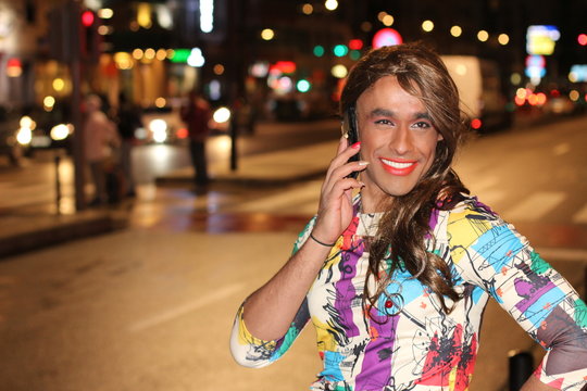 African American transgender woman calling by phone outdoors