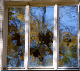Broken windows of residential homes in close-up