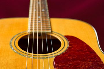 Obraz premium Rich color solid Spruce top acoustic guitar detail. Selective focus on strings.